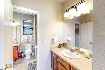 a bathroom with a sink and a toilet and a mirror at Summit Point Place in Granby