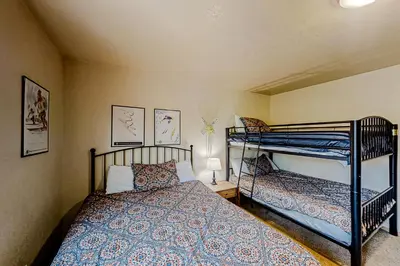 a bedroom with two bunk beds in a room at Hemlock Cabin in Granby