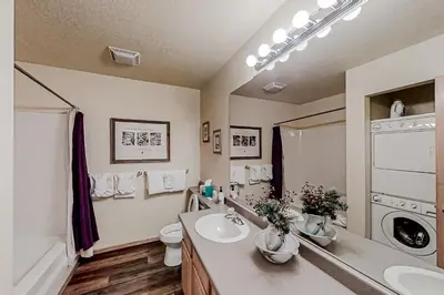 a bathroom with a sink and a washing machine at Hemlock Cabin in Granby
