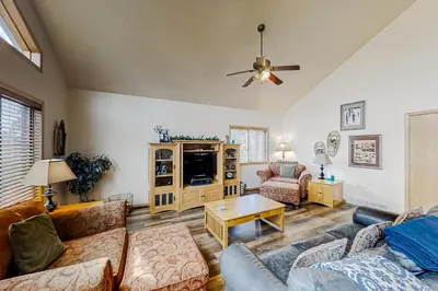 a living room with a couch and a table at Hemlock Cabin in Granby