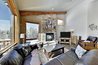 a living room with a couch and a fireplace at The Antlers 401 in Winter Park