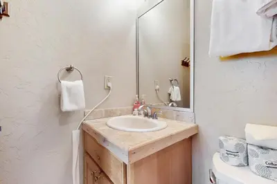 a bathroom with a sink and a mirror at The Antlers 401 in Winter Park