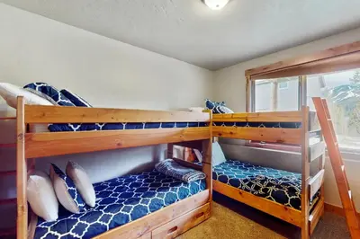 two bunk beds in a room with a window at The Antlers 401 in Winter Park