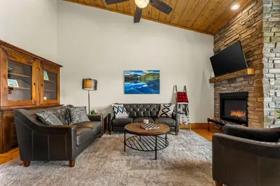 a living room with leather furniture and a fireplace at Infinity View in Grand Lake