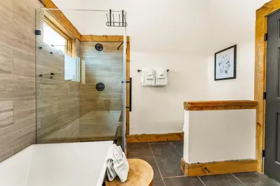 a bathroom with a shower with a glass door at Infinity View in Grand Lake