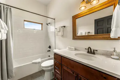 a bathroom with a sink and a toilet and a mirror at Infinity View in Grand Lake