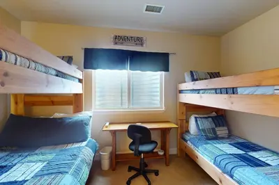 a bedroom with two bunk beds and a desk at Sagebrush Cabin in Granby