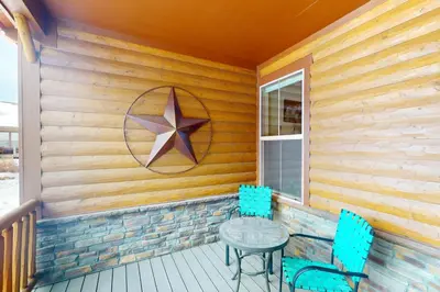 a table and chairs on a porch with a star on the wall at Sagebrush Cabin in Granby