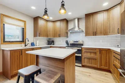 a kitchen with wooden cabinets and a white counter top at Wapiti Townhouse 3 in Fraser