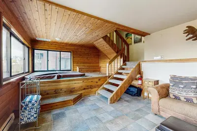 a room with a sauna with a staircase and a couch at Wapiti Townhouse 3 in Fraser