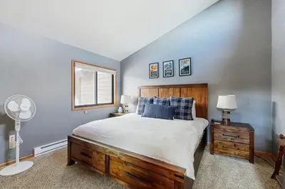 a bedroom with a large bed and a window at Wapiti Townhouse 3 in Fraser