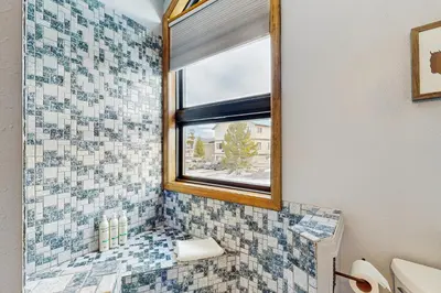 a bathroom with a window and a sink and a mirror at Wapiti Townhouse 3 in Fraser