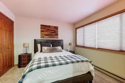 a bedroom with a bed and a large window at Wapiti Townhouse 3 in Fraser