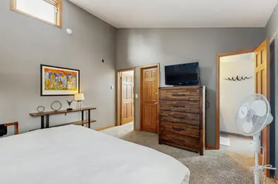 a bedroom with a bed and a flat screen tv at Wapiti Townhouse 3 in Fraser