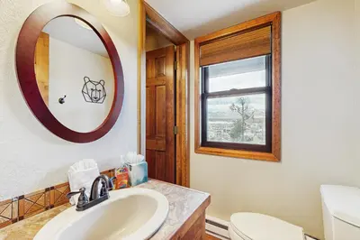 a bathroom with a sink and a mirror at Wapiti Townhouse 3 in Fraser