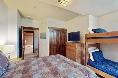 a bedroom with a bunk bed and a television at Cozens Pointe D201 in Fraser