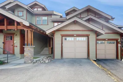 a house with two garage doors in a driveway at Cozens Pointe D201 in Fraser