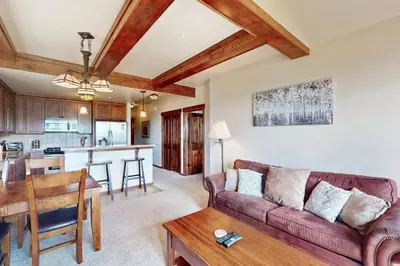 a living room with a couch and a table at Cozens Pointe D201 in Fraser