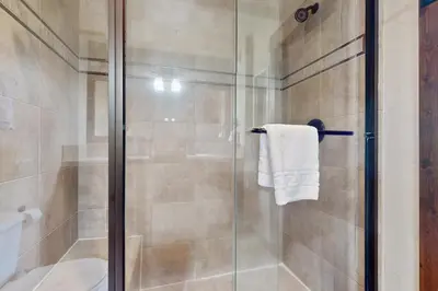 a shower stall with a glass door in a bathroom at Cozens Pointe D201 in Fraser
