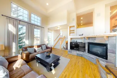 a living room with a couch and a fireplace at Red Quill Village in Winter Park