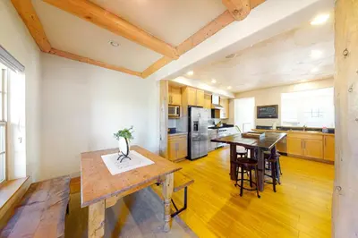 a kitchen with wooden floors and a table and chairs at Red Quill Village in Winter Park