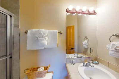 a bathroom with a sink and a mirror at Red Quill Village in Winter Park