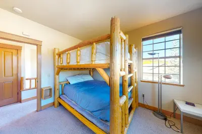 a bedroom with two bunk beds and a window at Red Quill Village in Winter Park