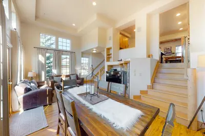 a living room with a dining table and a living room at Red Quill Village in Winter Park