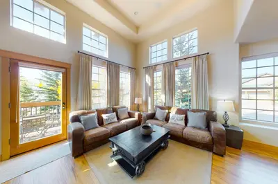 a living room with a couch and a table at Red Quill Village in Winter Park