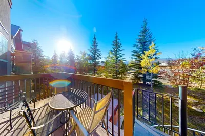 a patio with a table and chairs on a balcony at Red Quill Village in Winter Park