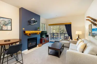 a living room with a couch and a fireplace at The Seasons 1834 condo in Keystone