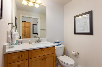 a bathroom with a sink and a toilet and a mirror at The Seasons 1834 condo in Keystone
