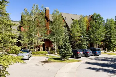a building with cars parked in a parking lot at The Seasons 1834 condo in Keystone
