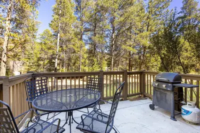 a patio with a grill and a table and chairs at The Seasons 1834 condo in Keystone