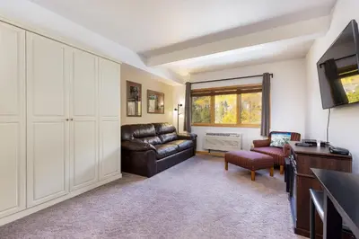a living room with a leather couch and a television at 5087 Gateway home in Keystone