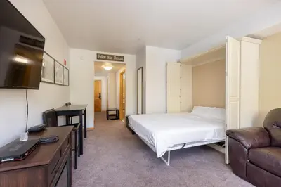 a bedroom with a bed and a couch and a desk at 5087 Gateway home in Keystone