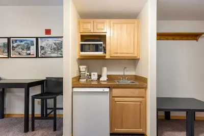 a small kitchen with a sink and a microwave at 5087 Gateway home in Keystone