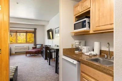 a kitchen with a sink and a microwave at 5087 Gateway home in Keystone