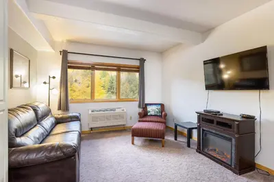a living room with a couch and a television at 5087 Gateway home in Keystone