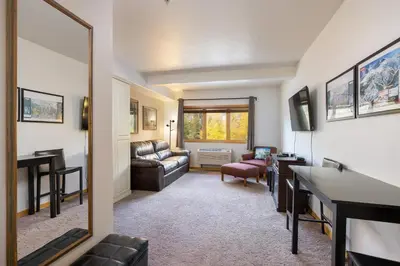 a living room with a couch and a mirror at 5087 Gateway home in Keystone