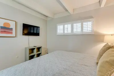 a bedroom with a bed and a tv on the wall at Walk to Main St! Condo with Hot Tub and Pool in Frisco in Frisco