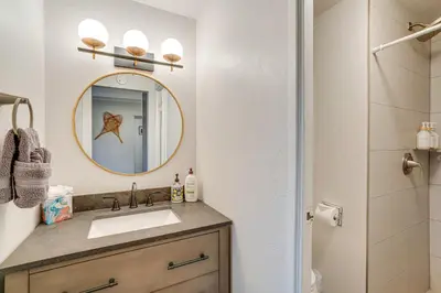 a bathroom with a sink and a mirror at Walk to Main St! Condo with Hot Tub and Pool in Frisco in Frisco