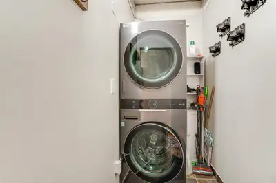 a washer and dryer in a room at Walk to Main St! Condo with Hot Tub and Pool in Frisco in Frisco