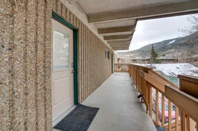 a door on the side of a building with a balcony at Walk to Main St! Condo with Hot Tub and Pool in Frisco in Frisco