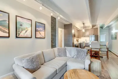 a living room with a white couch and a table at Walk to Main St! Condo with Hot Tub and Pool in Frisco in Frisco