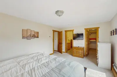 a bedroom with a white bed and a television at The Cove Retreat in Dillon