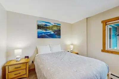 a bedroom with a white bed and a window at The Cove Retreat in Dillon