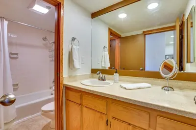 a bathroom with a sink and a toilet and a mirror at 1 Mi to Keystone Ski Lift Lakefront 4-Season Gem in Dillon