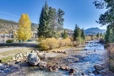 a river with rocks and trees in the foreground at 1 Mi to Keystone Ski Lift Lakefront 4-Season Gem in Dillon