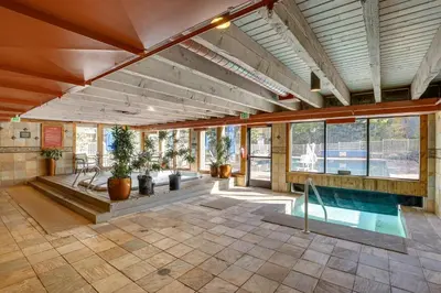a large room with a swimming pool in a house at 1 Mi to Keystone Ski Lift Lakefront 4-Season Gem in Dillon